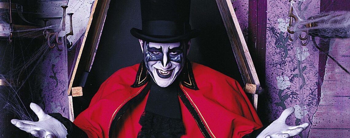 Darkus Knight, a ghoul character with a full painted face, black top hat and long red cape